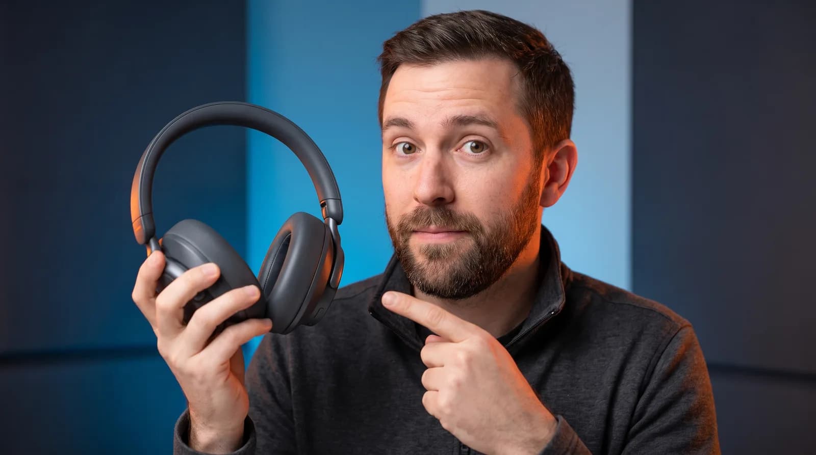 A real 1280x720 landscape thumbnail example — a tech reviewer holding a product